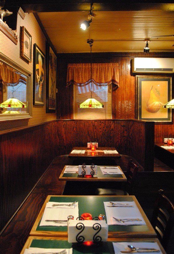 wood dining tables with pendants over them