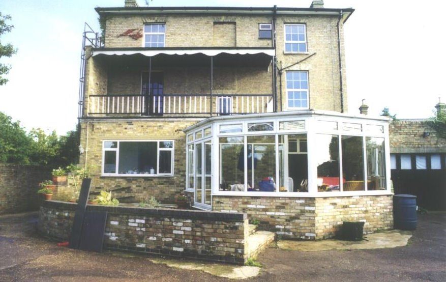 A large house with a conservatory and a balcony