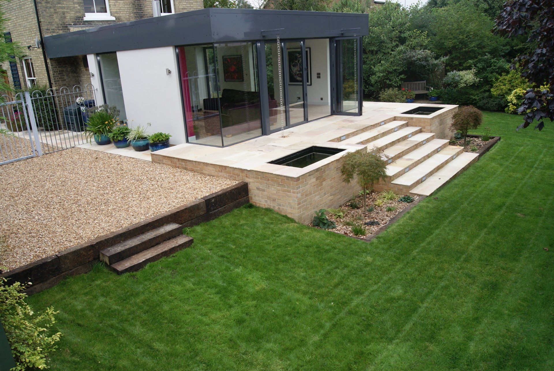 A house with a large patio and stairs in the backyard.