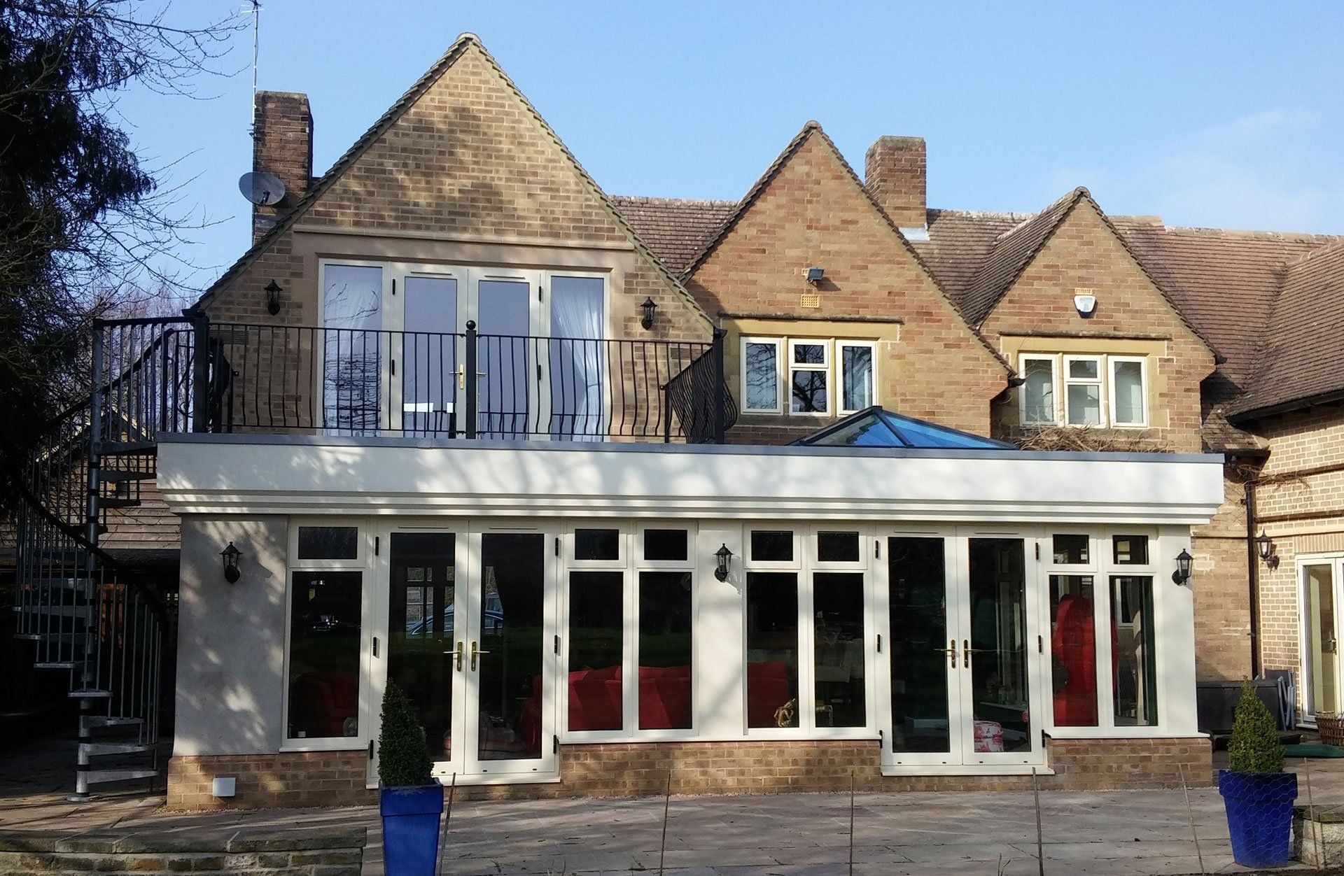 A large brick house with a balcony and lots of windows