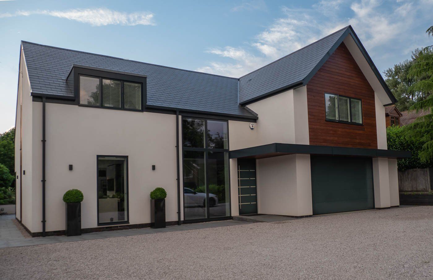 A large house with a garage and a driveway in front of it.
