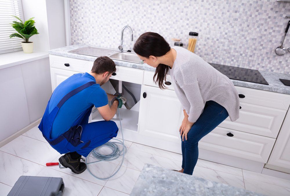 Man Repairing Sink Drain — Midland, TX — Randy's Rooter & Plumbing LLC Man Repairing Sink Drain — Midland, TX — Randy's Rooter & Plumbing LLC