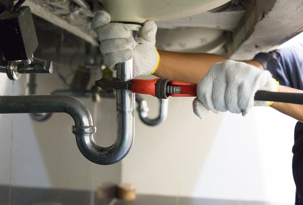 Plumber Repairing Sink Drain — Midland, TX — Randy's Rooter & Plumbing LLC Plumber Repairing Sink Drain — Midland, TX — Randy's Rooter & Plumbing LLC