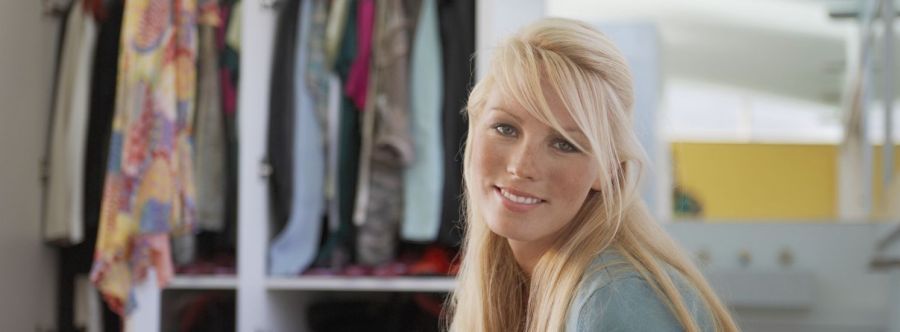 Smiling girl in front of her wardrobe