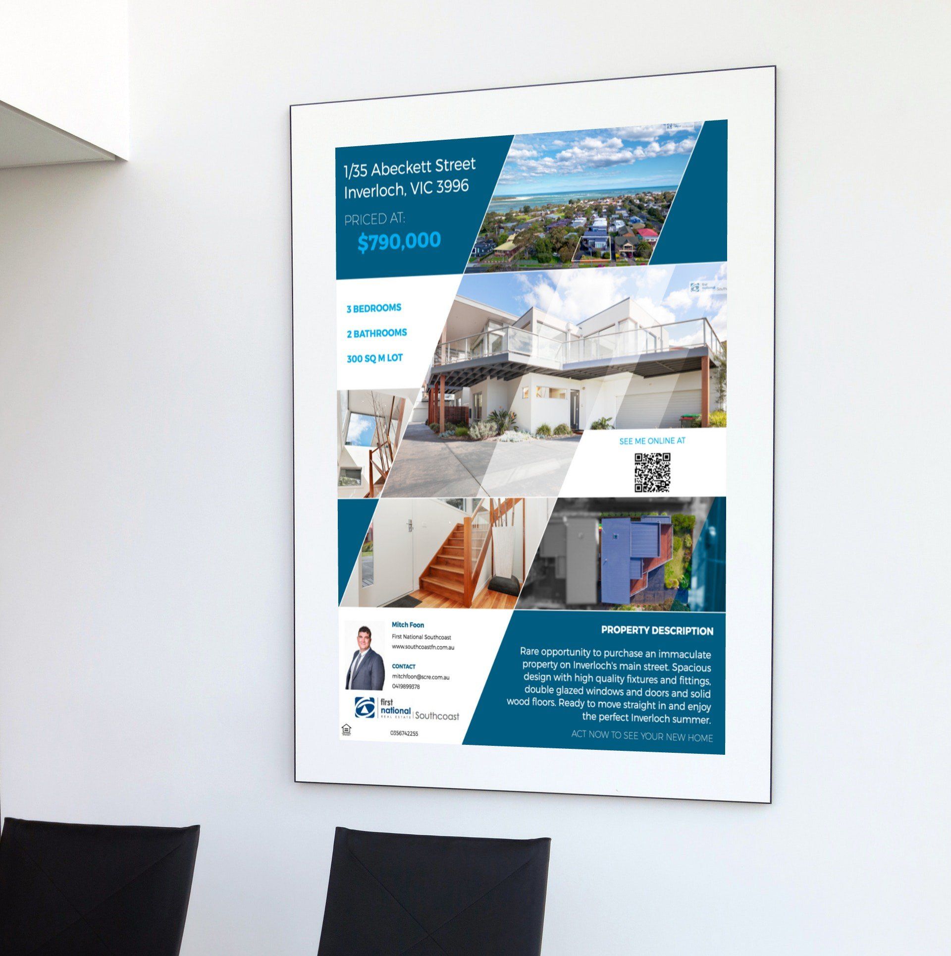 Blue-and-white real estate poster mounted on a white wall in a modern interior.