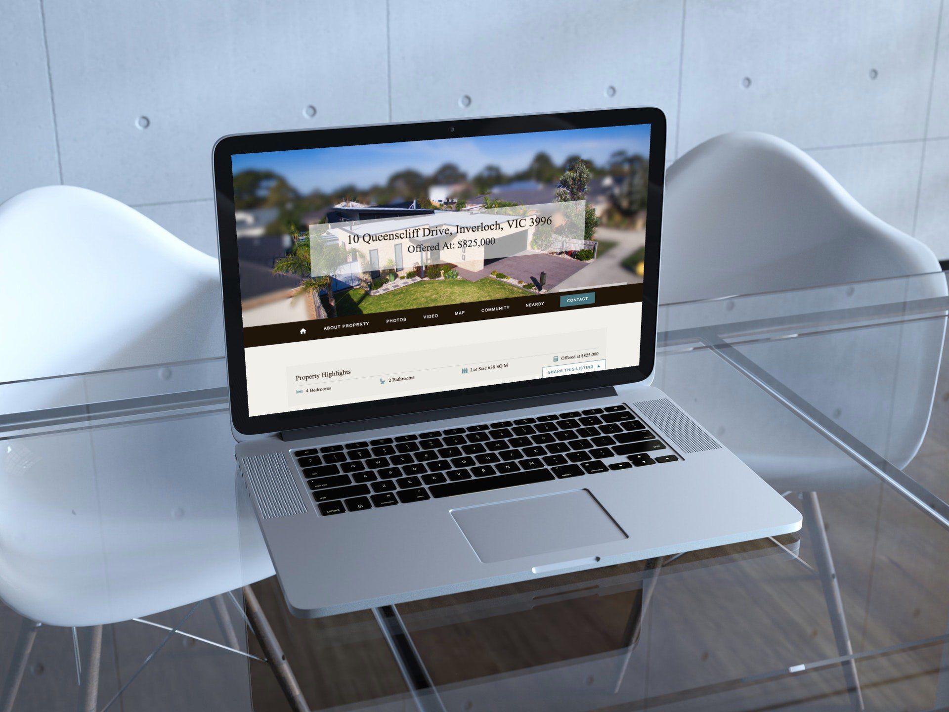 Silver laptop on a clear acrylic table, showing a website in a white room.