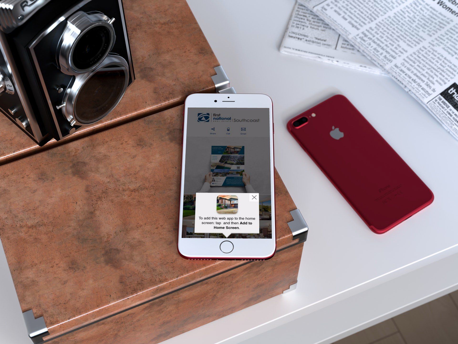 Two smartphones on a white table beside a vintage camera and newspaper.