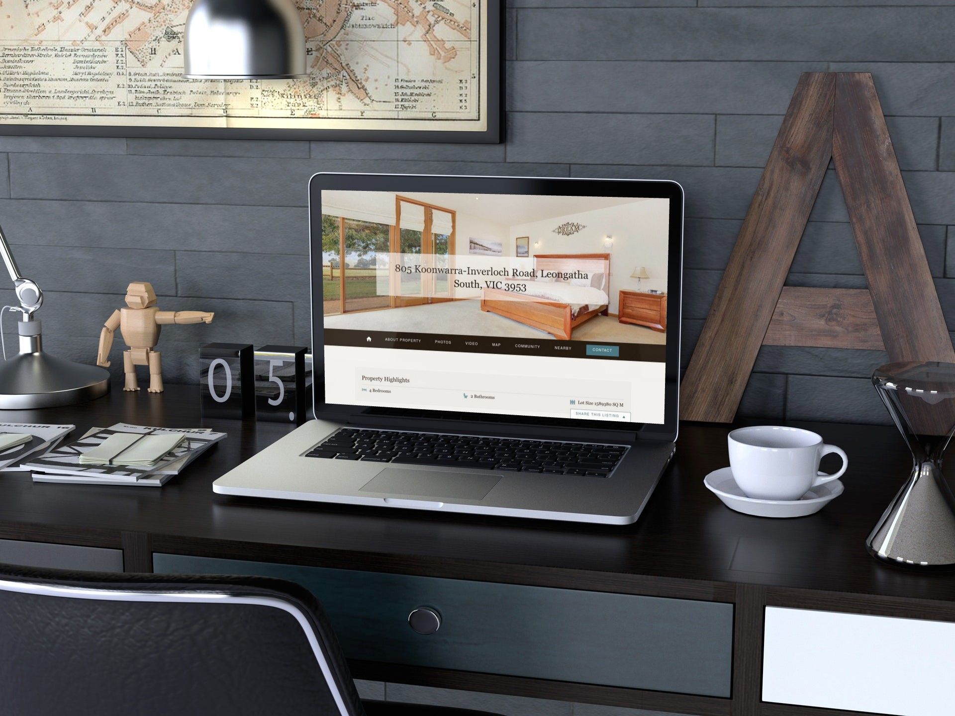 Modern desk workspace with laptop, coffee cup, lamp, and decor on a dark wooden desk.