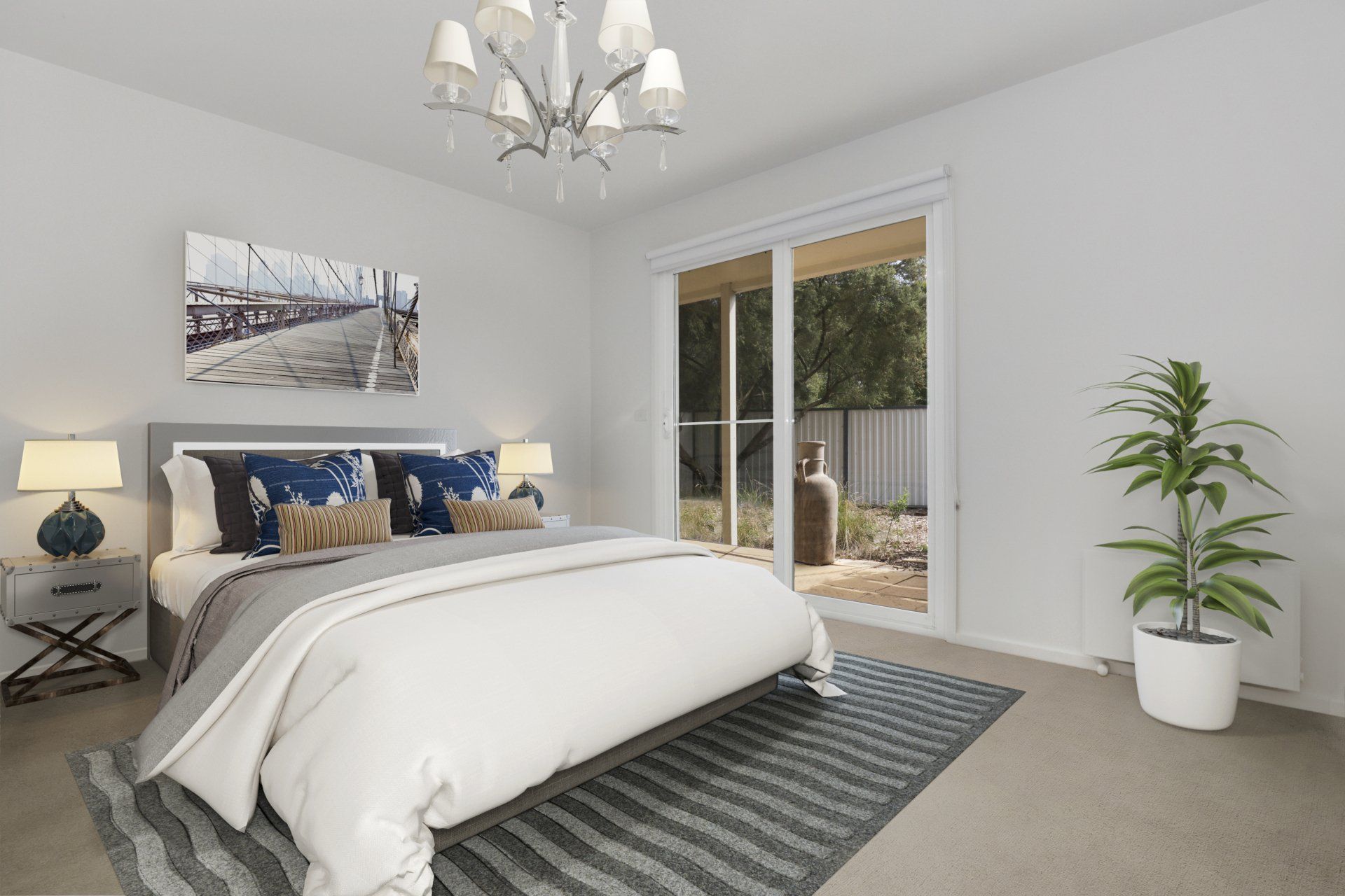 Bright bedroom with a white bed, gray rug, chandelier, and sliding glass doors to a patio.