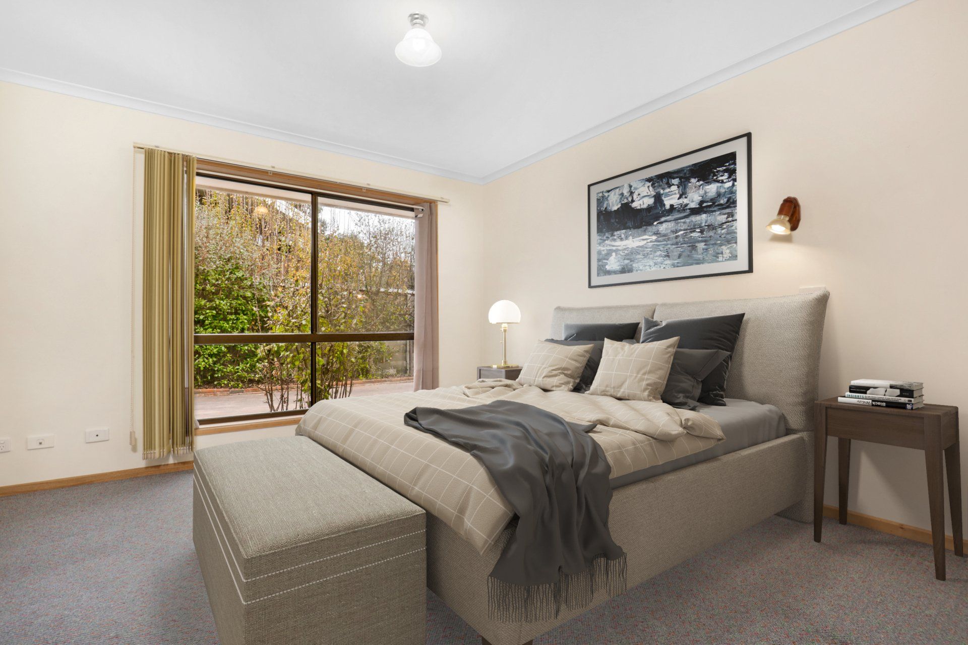 Bright bedroom with a made bed, window view, and gray decor underneath framed wall art
