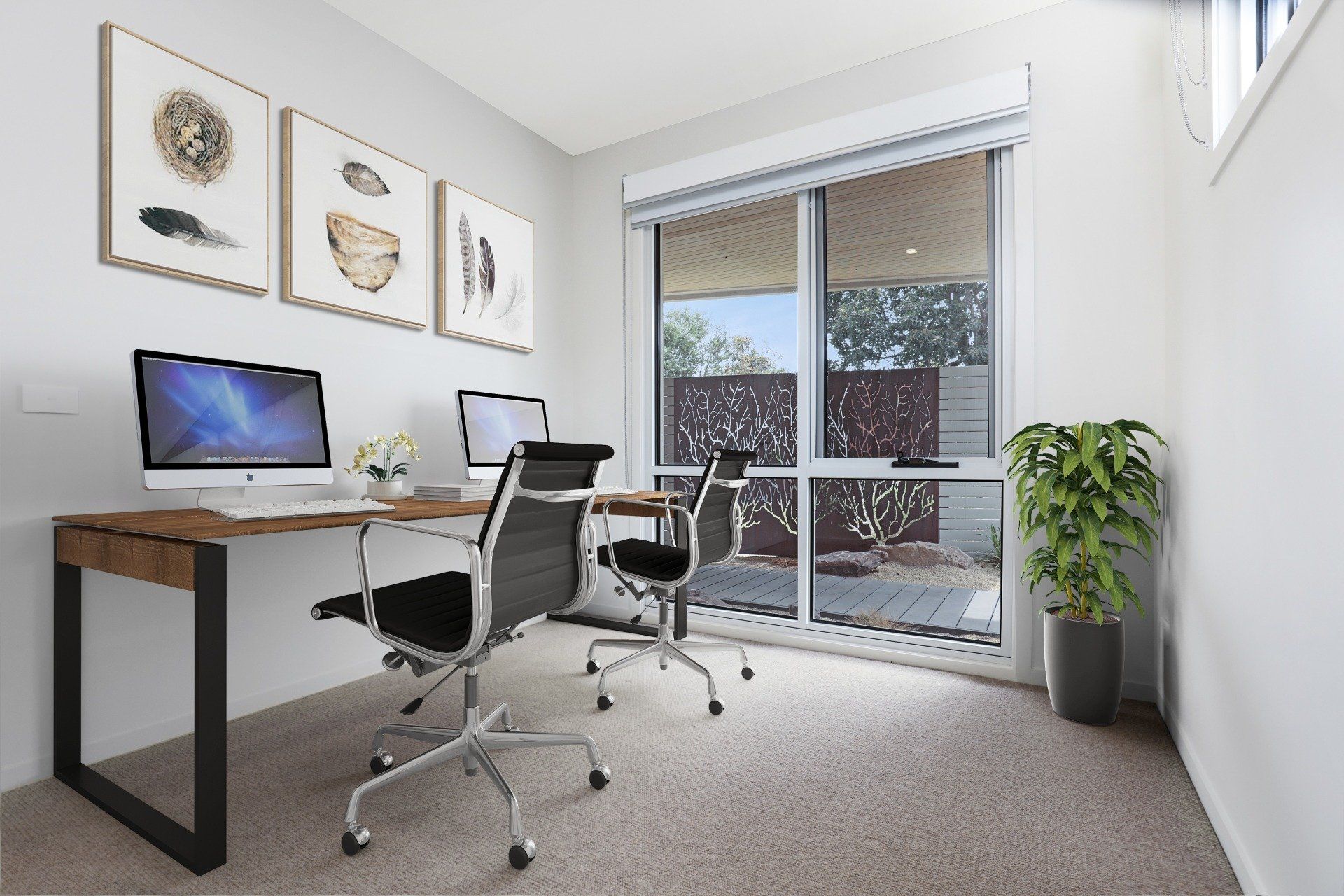 Bright home office with two desks, swivel chairs, wall art, and a sliding glass door to a balcony.