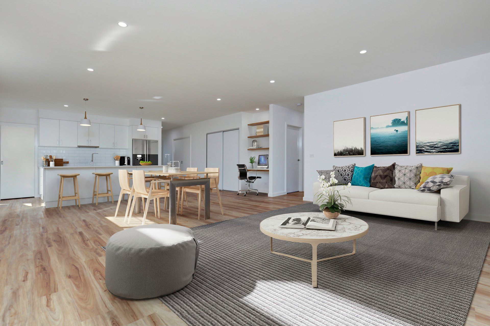 Bright open-plan living room with gray sofa, wood dining table, kitchen, and ocean-themed wall art.