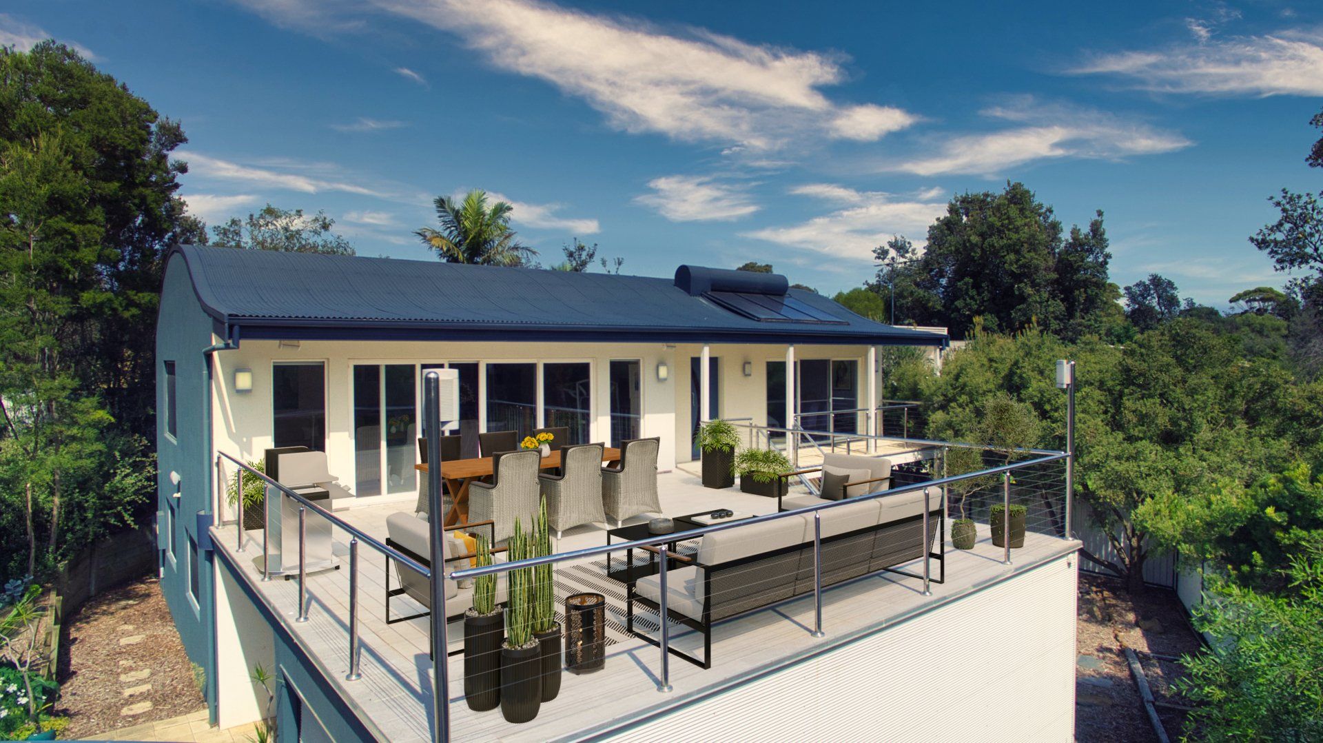 Modern house with rooftop terrace, outdoor seating, and panoramic greenery under a blue sky
