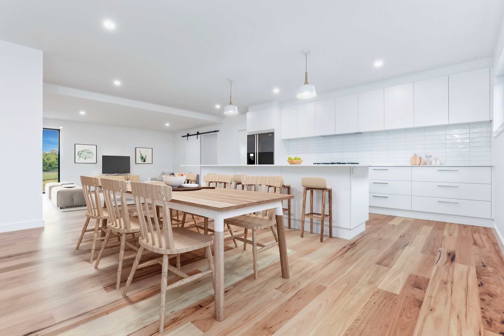 Bright modern kitchen and dining area with white cabinets, wood floors, and a long wooden table