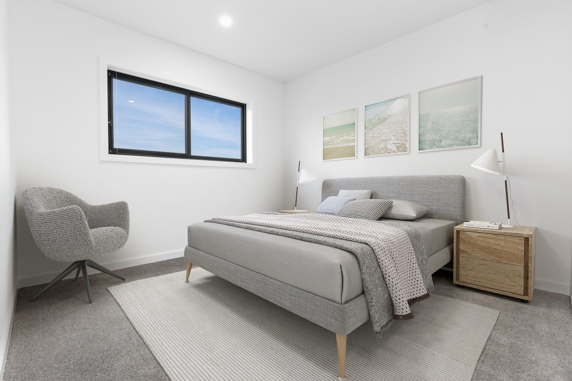 Bright modern bedroom with gray bed, woven chair, window, and soft neutral decor