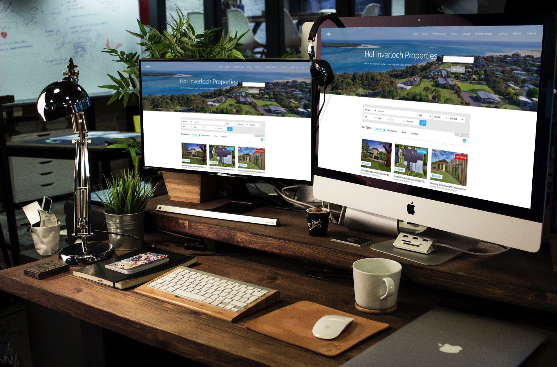 Dual-monitor desktop setup on a wooden desk with keyboard, mouse, coffee mug, and two small model airplanes.