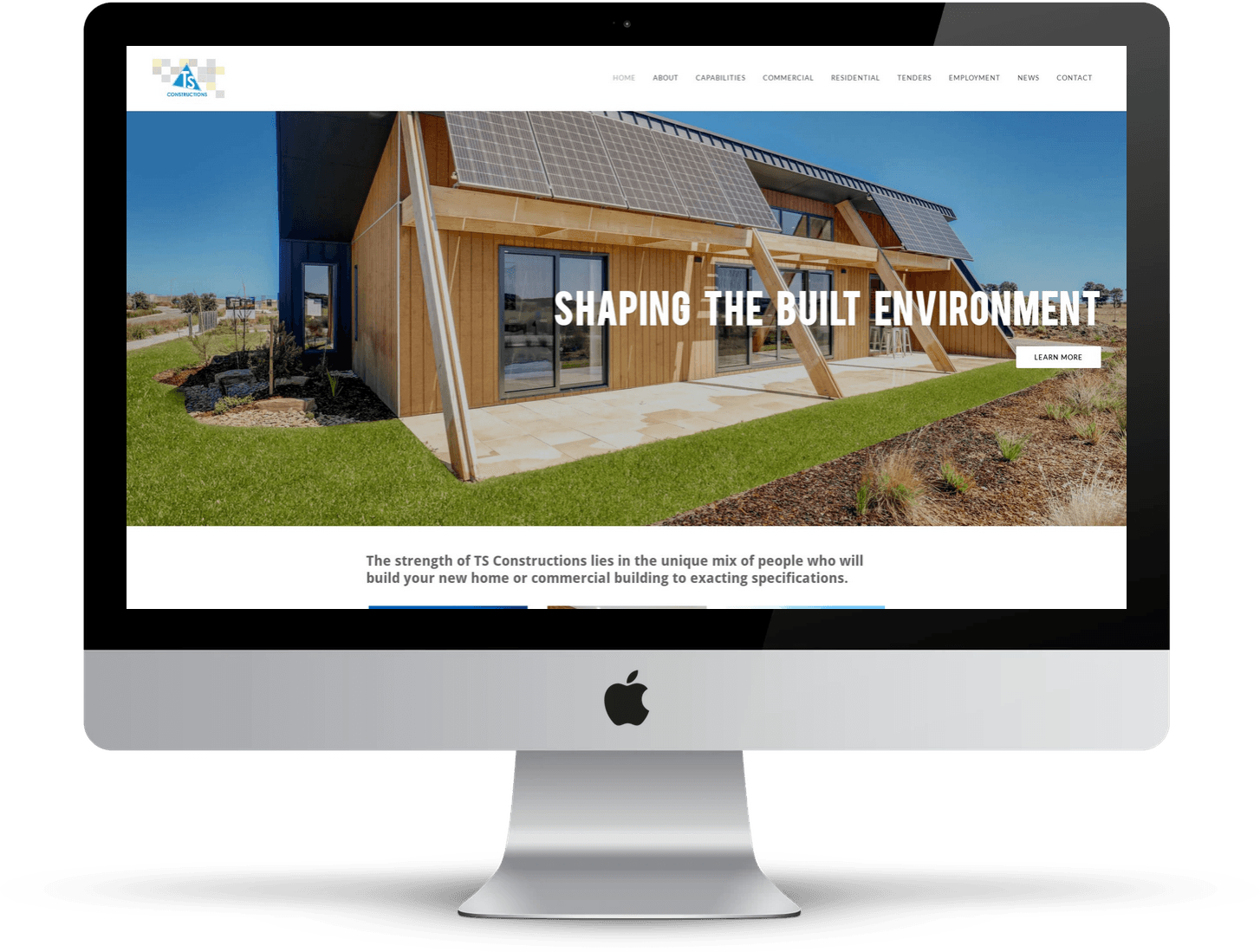IMac displaying a construction company website with a building and landscape photo