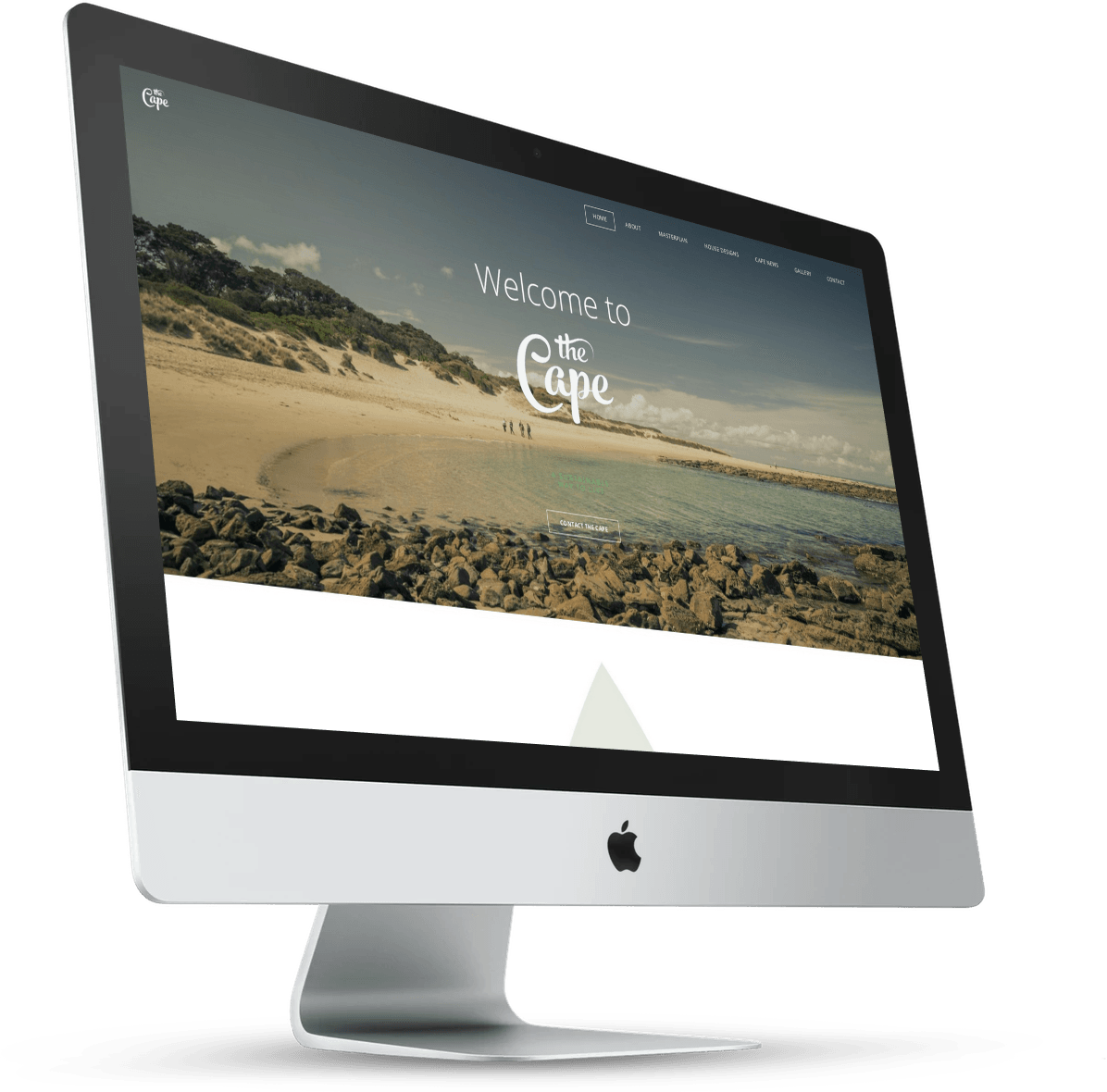 Silver iMac desktop computer displaying a beach scene on its screen, angled slightly left.