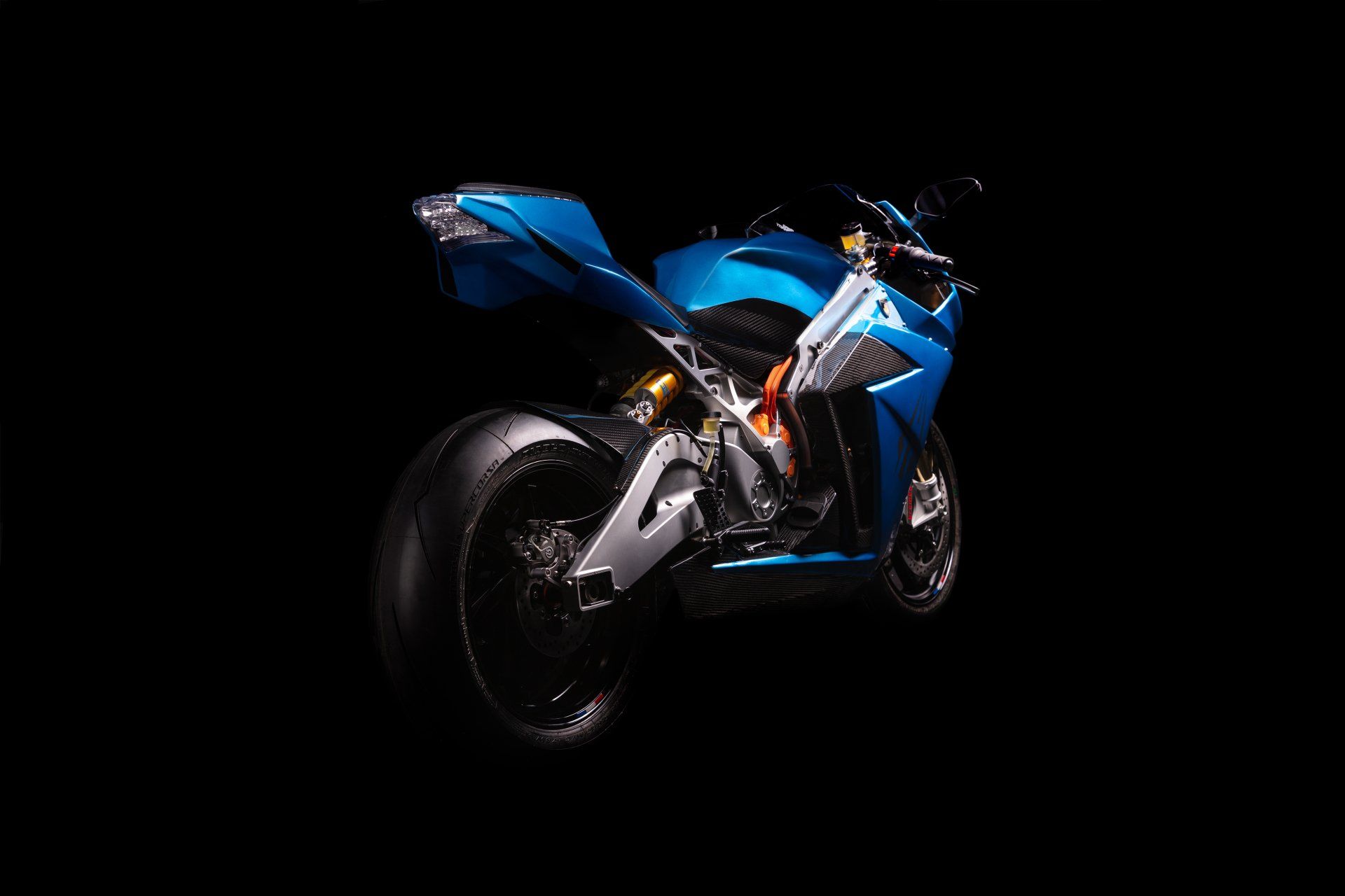 Blue electric sport motorcycle against a black background.