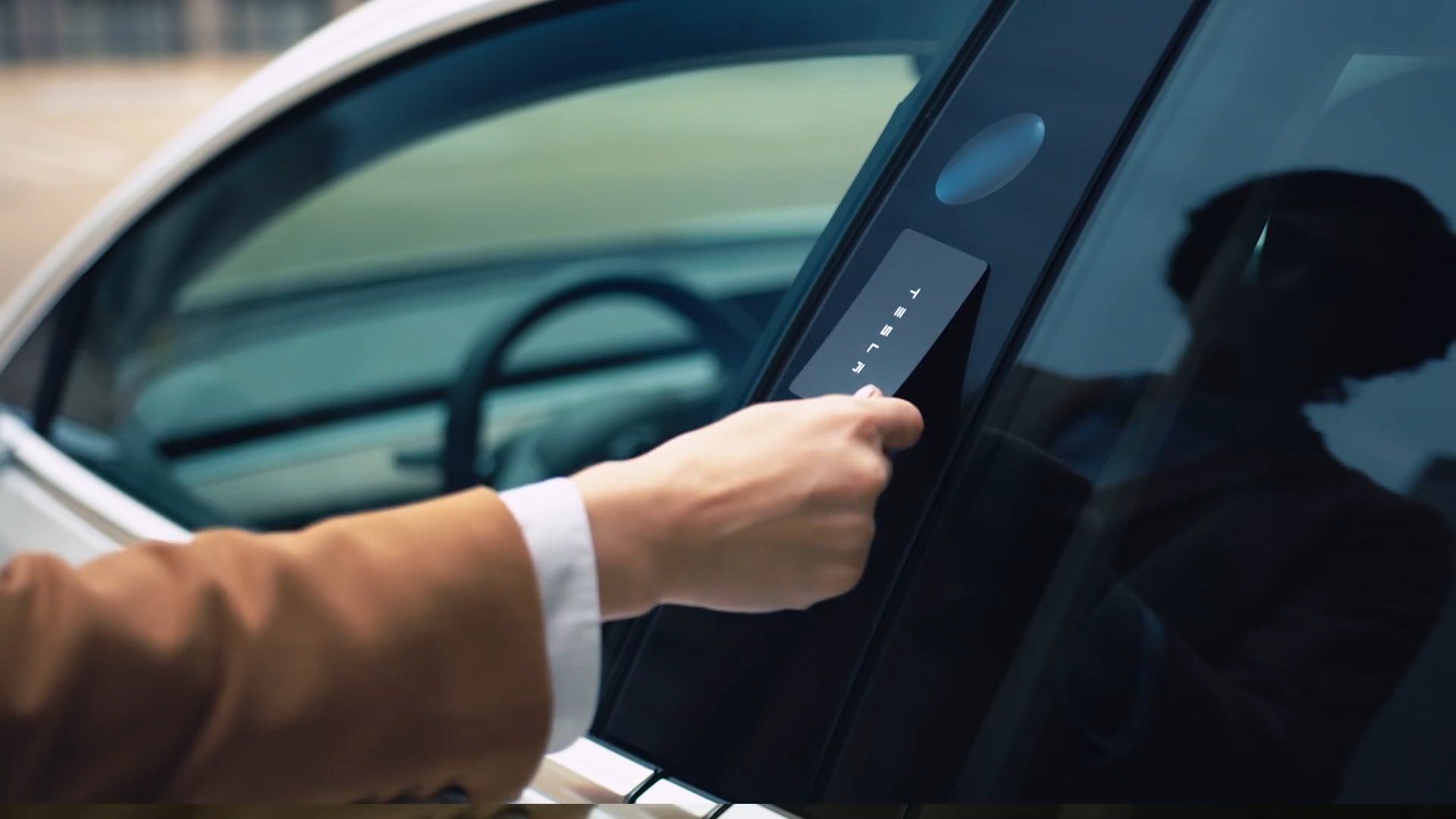 A person using a key card to unlock a car door.