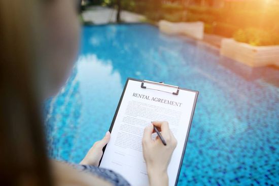 man reading the rental agreement