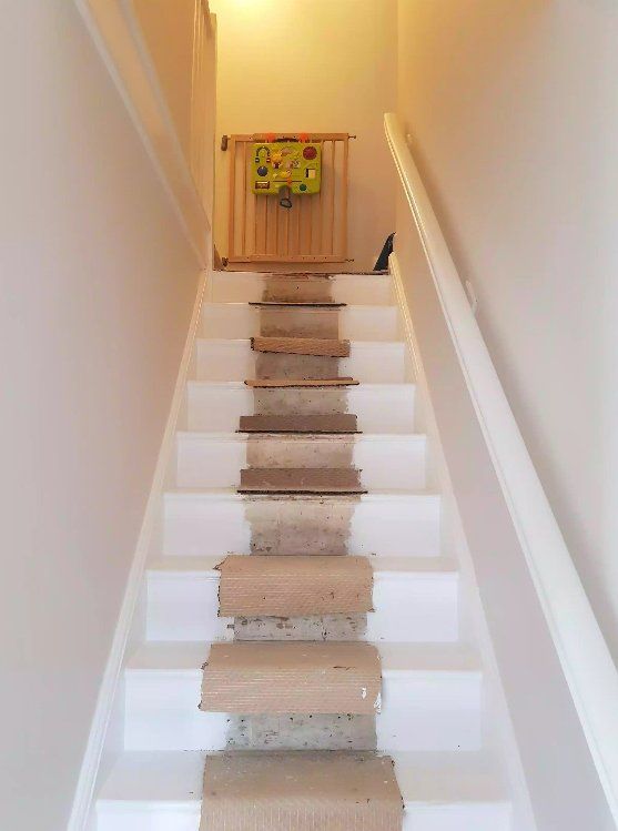 Freshly painted white staircase prepared for new carpet in York