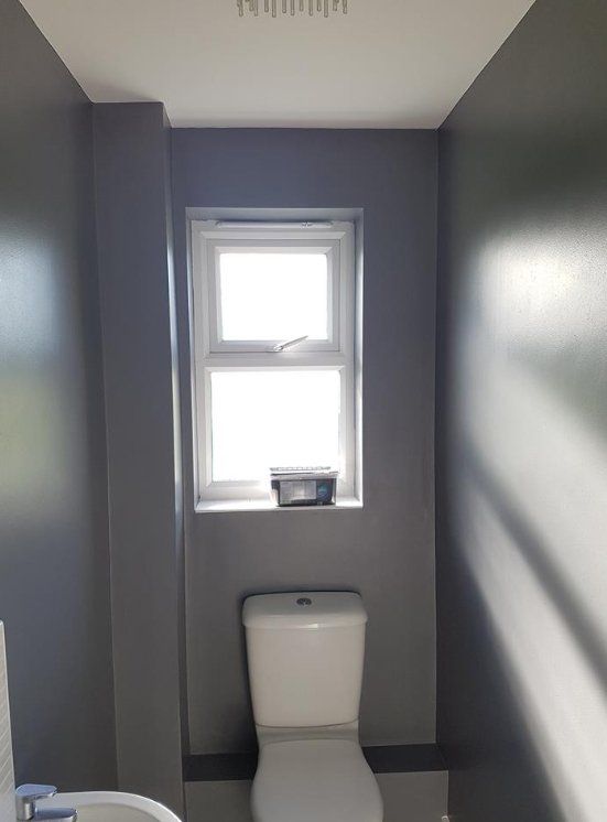 Small bathroom painted dark grey with a crisp white ceiling in York