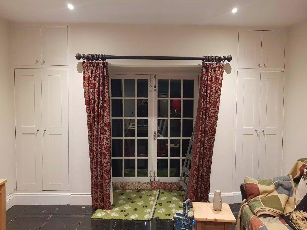 White built-in cabinets around French doors in a York living room