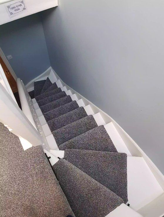 Finished grey staircase with white woodwork and grey carpet in York