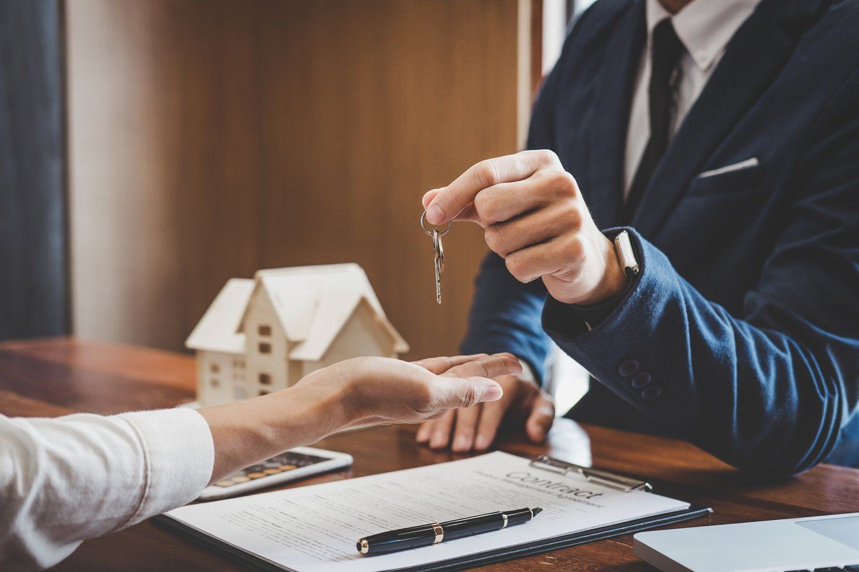Estate Planning Lawyer handing keys to client