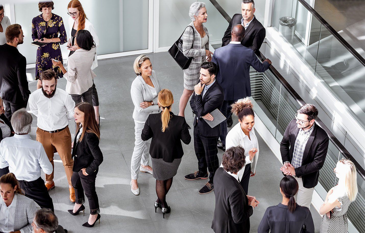 People congregating together and networking  in a corporate setting