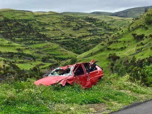 A car abandoned at the side of the road after an accidental collision.