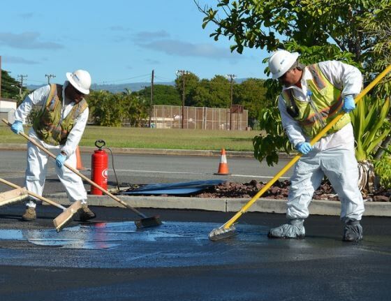 pavement cracking — worker of Q-Stripe for road sealing in Evansville, IN pavement cracking — worker of Q-Stripe for road sealing in Evansville, IN