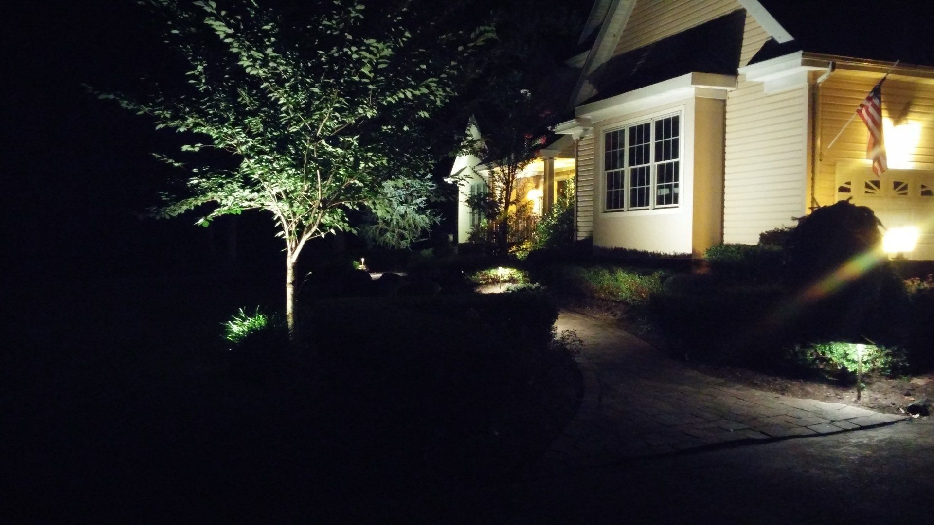 Small Solar Garden Light, Lanterns In Flower Bed. Garden Design. Solar Powered Lamp