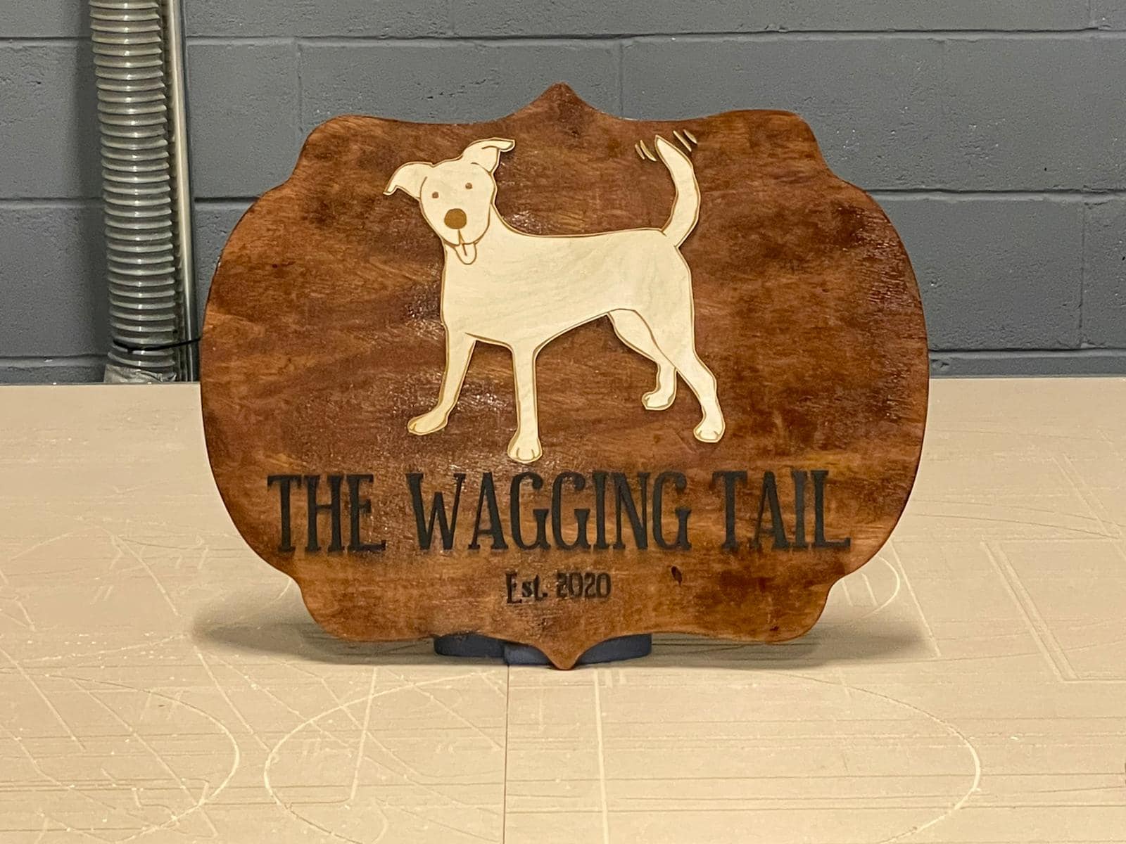 Wooden sign with a dog silhouette and text 