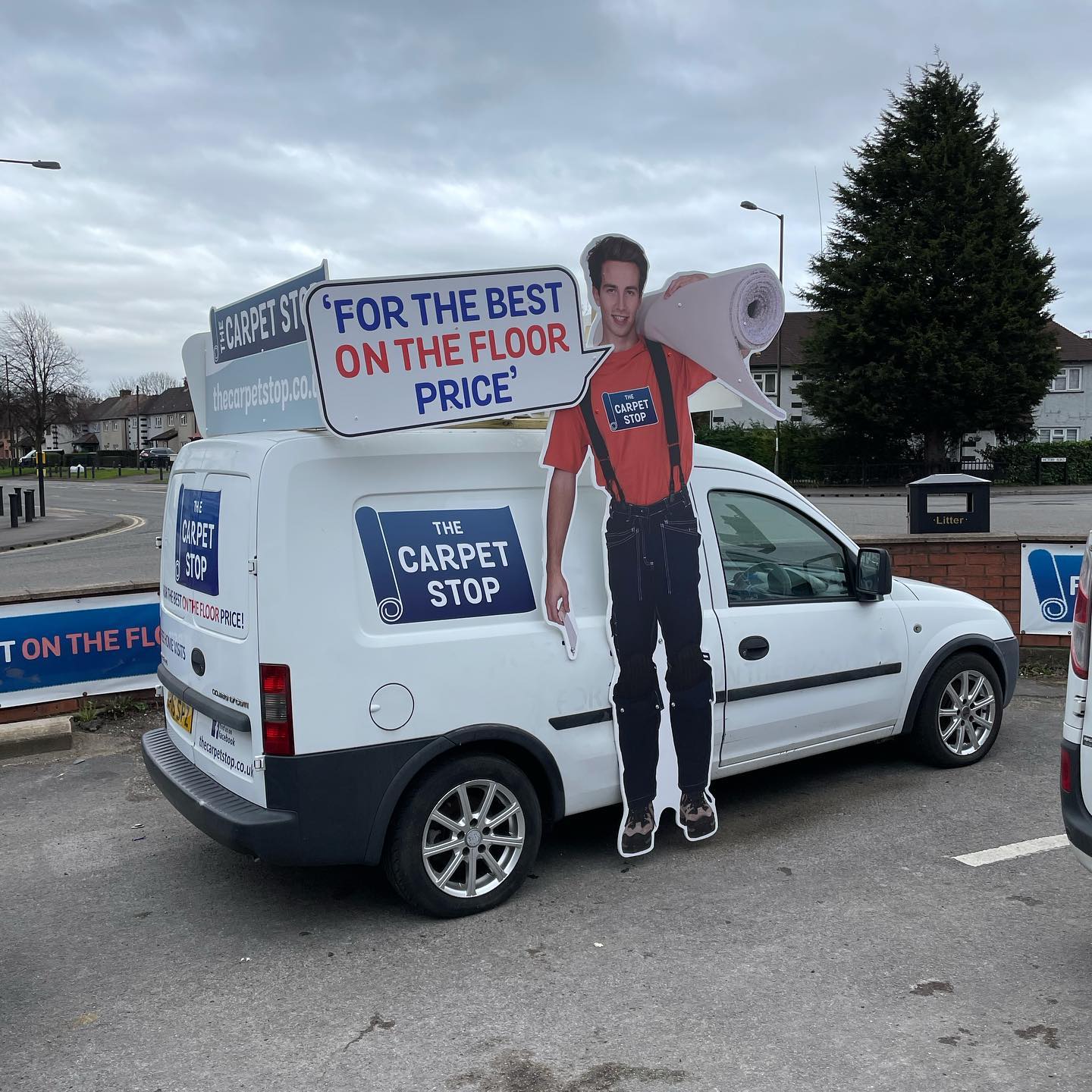 White Carpet Stop van with cutout of man holding carpet; signage reads 