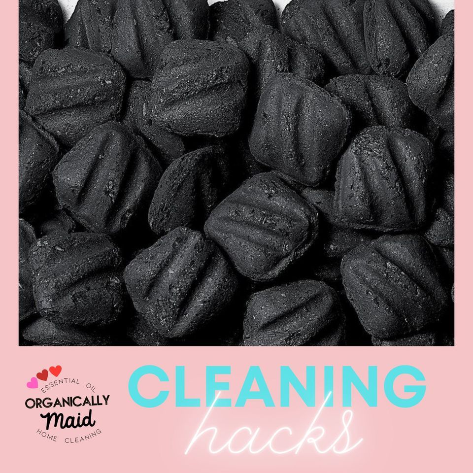 A pile of charcoal briquettes on a pink background with the text