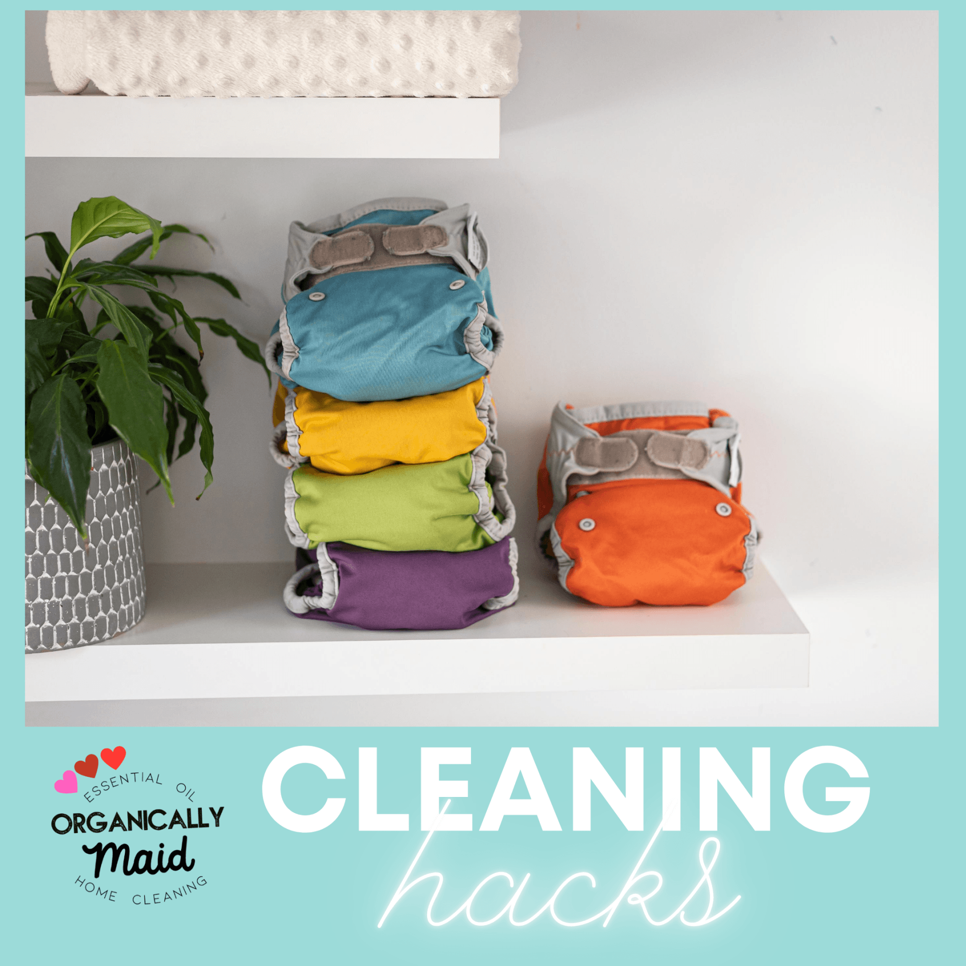 A stack of colorful cloth diapers and a single orange diaper on a white shelf next to a plant, with 