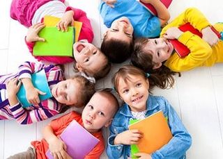 Kids holding notebook - Early Childhood Education in Fall River, MA