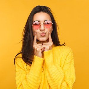 UV Protection — Woman in Sunglasses Touching Cheeks in Manasquan, NJ