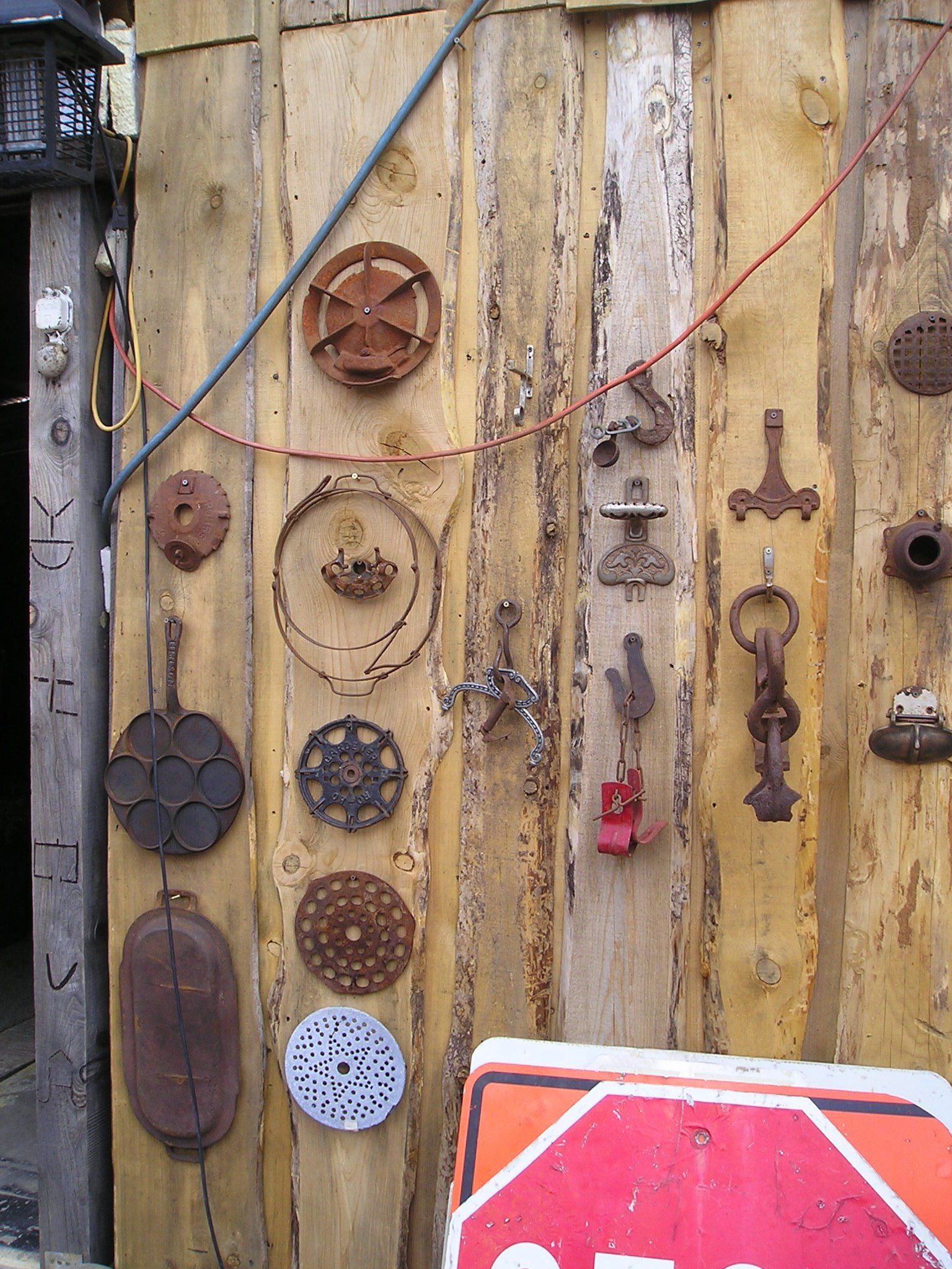 A wooden wall with a stop sign in front of it