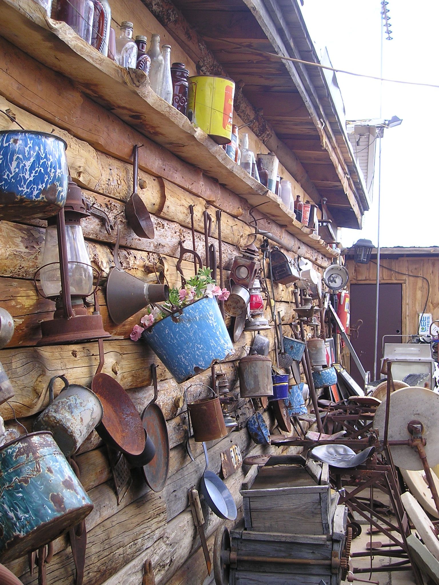 A wooden wall filled with lots of old items