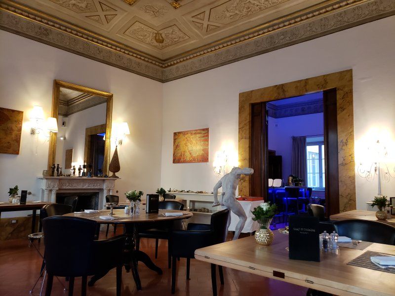 A dining room with tables and chairs and a fireplace