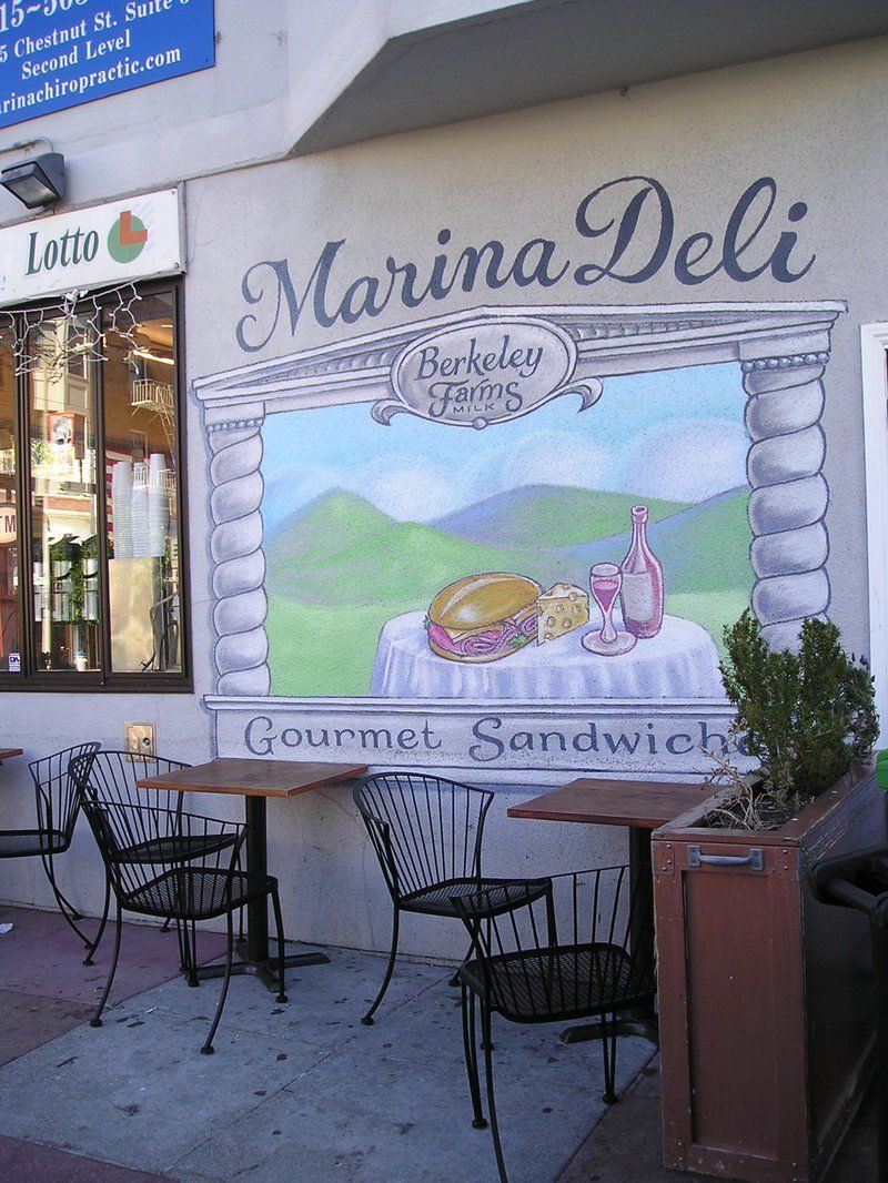 A marina deli restaurant with tables and chairs outside