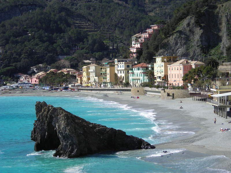 A beach with a large rock in the middle of it