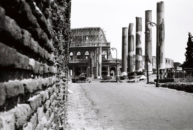 A black and white photo of the colosseum in rome