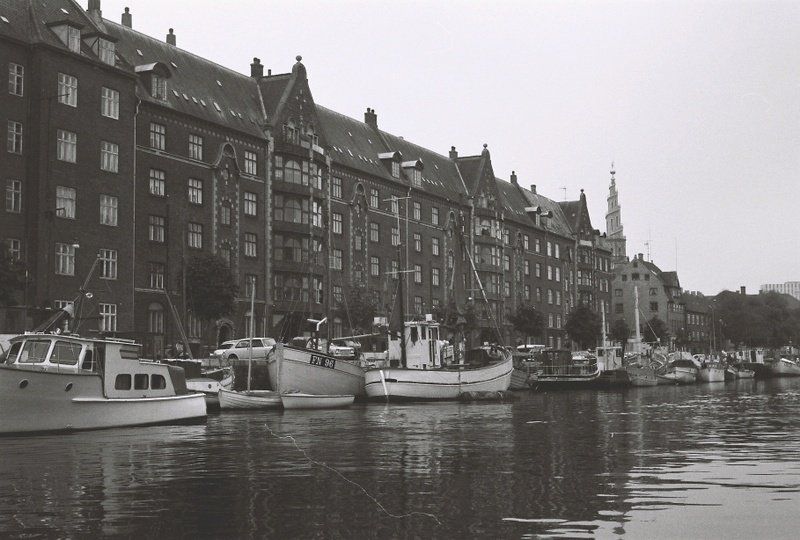 A black and white photo of boats in a harbor