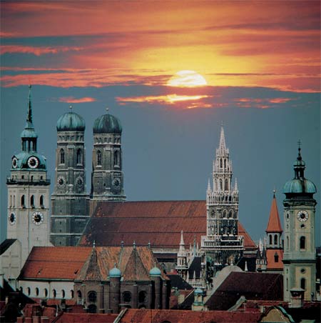A city skyline with a sunset in the background