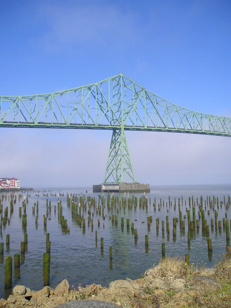 A bridge over a body of water with a blue sky in the background