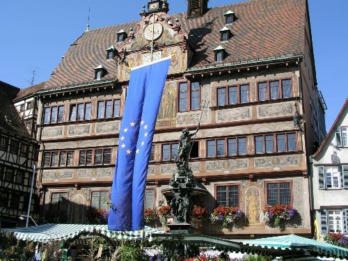 A large building with a blue flag in front of it